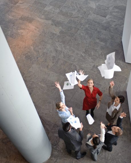 business-team-throwing-papers-in-the-air-2023-11-27-05-36-19-utc-scaled.jpg